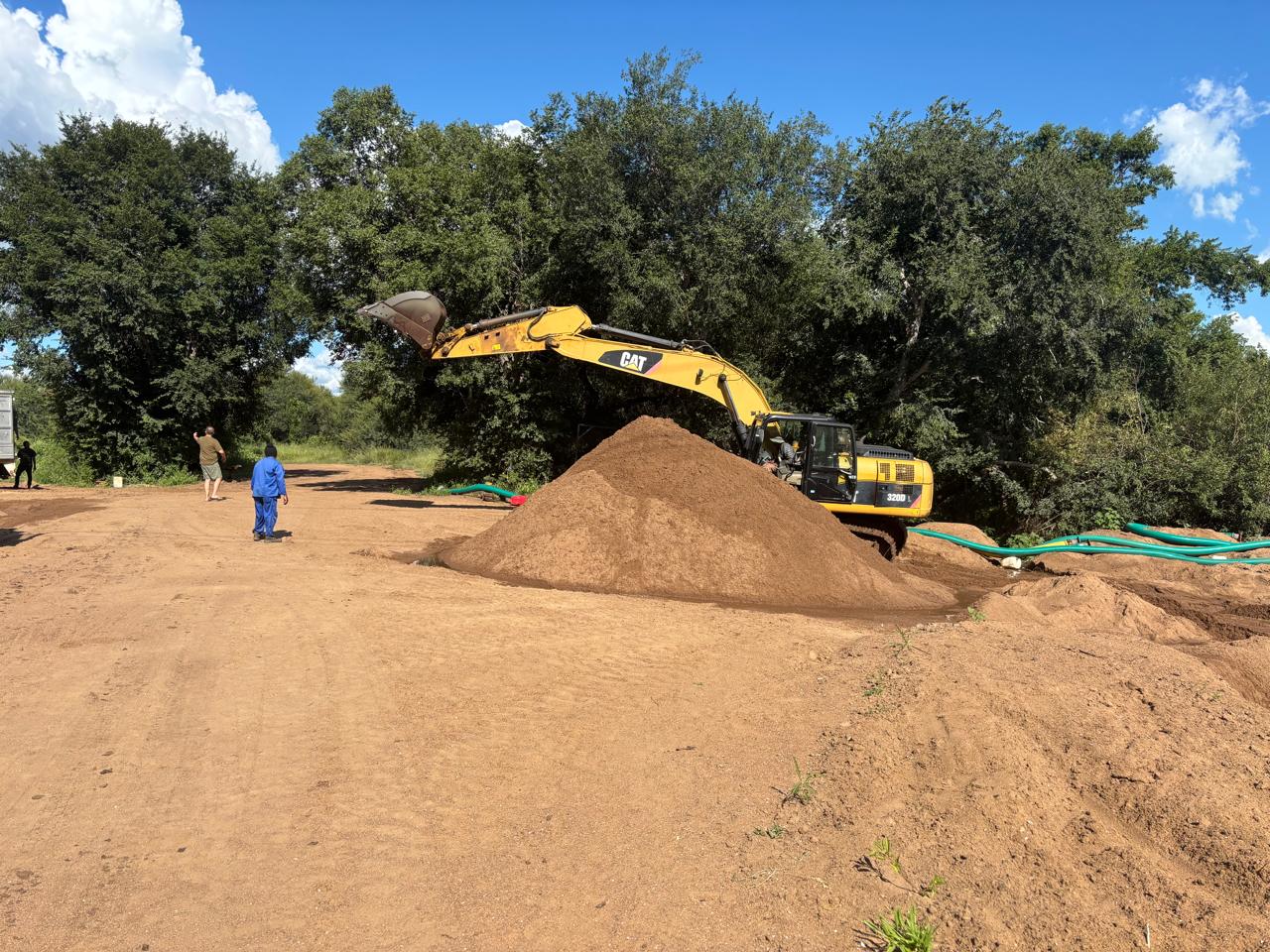 Sand stockpile and CAT excavator at the Impulse Mining operation